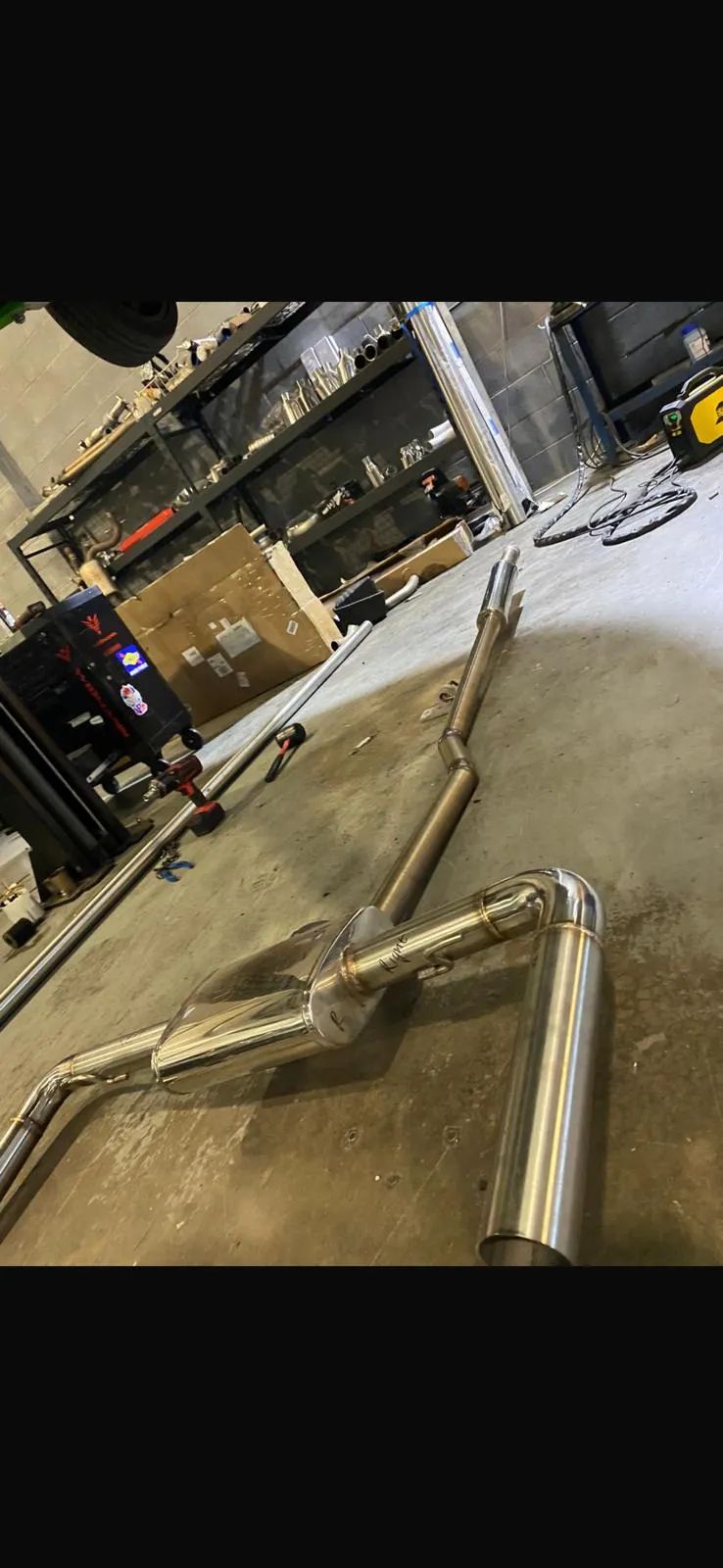 Complete custom exhaust system on workshop floor