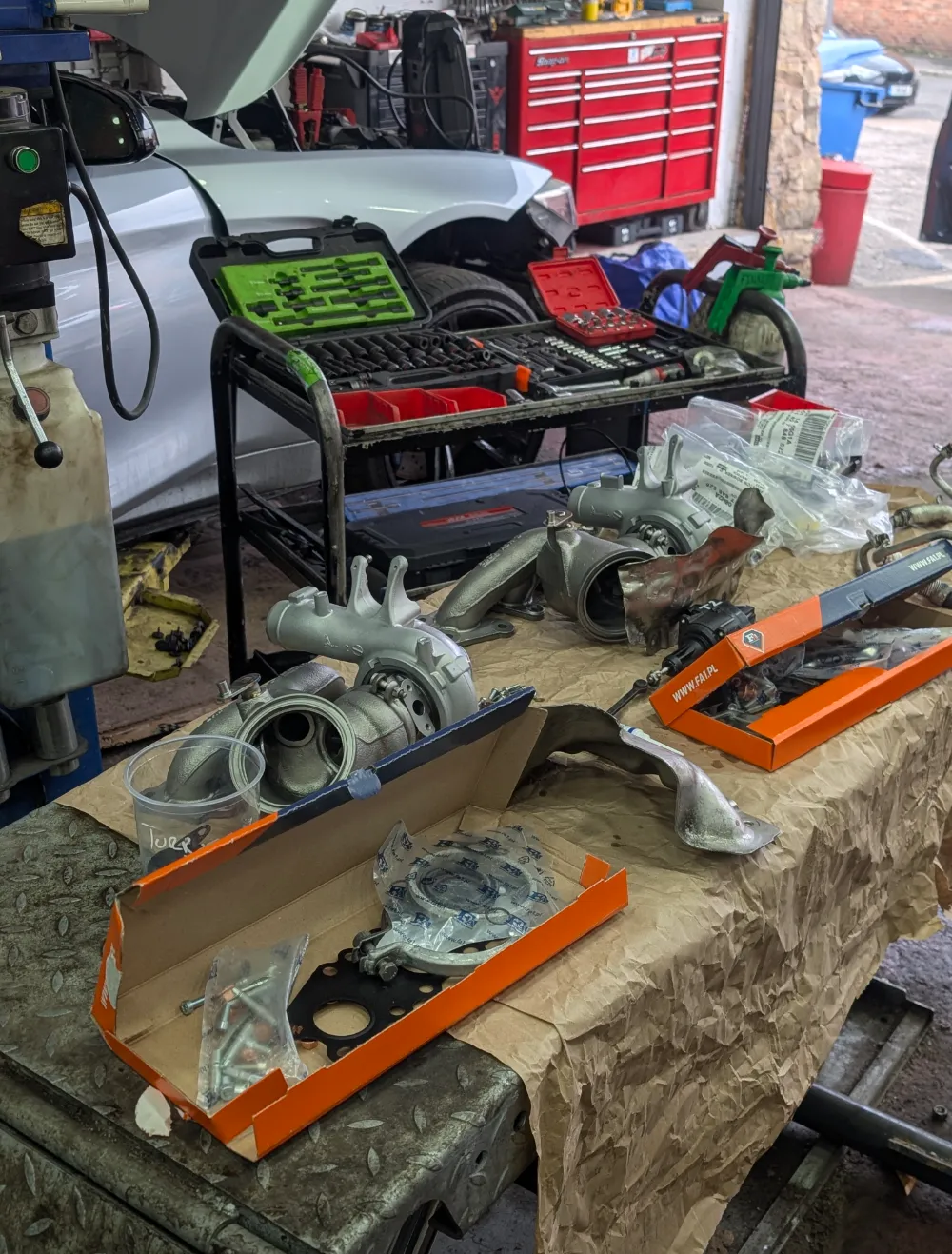 New turbo and gasket parts laid out on workbench